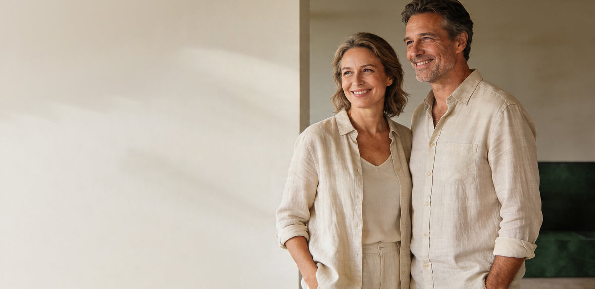 A smiling couple standing together in a bright room