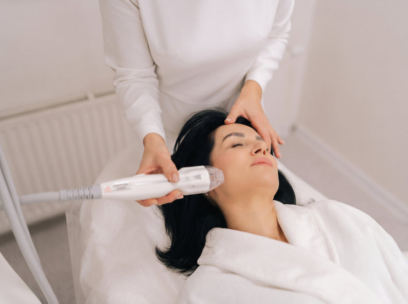 A microneedling treatment on a woman's forehead