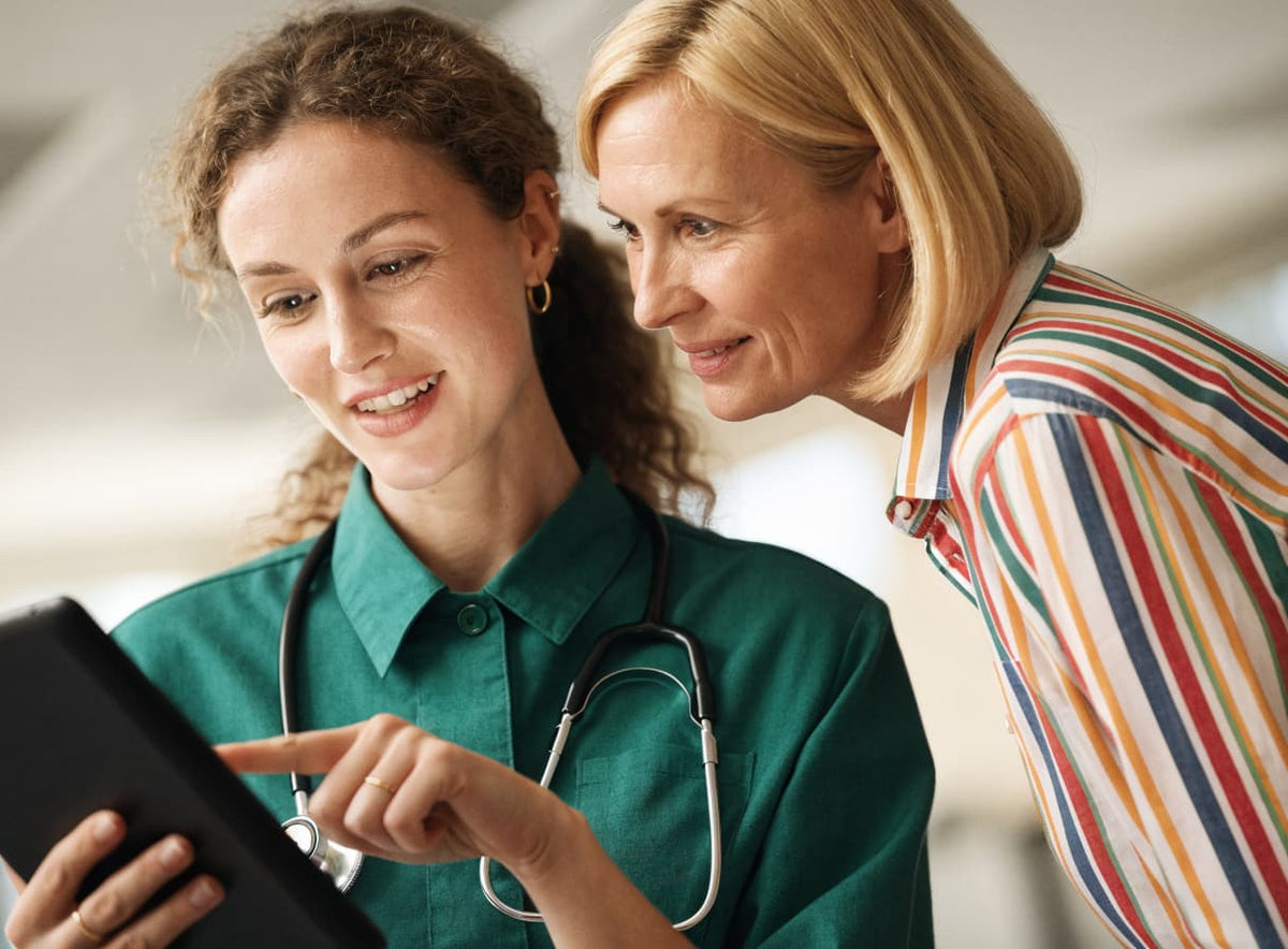 A nurse showing a patient information on a tablet