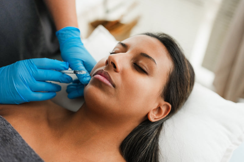 A woman receiving a cosmetic injection